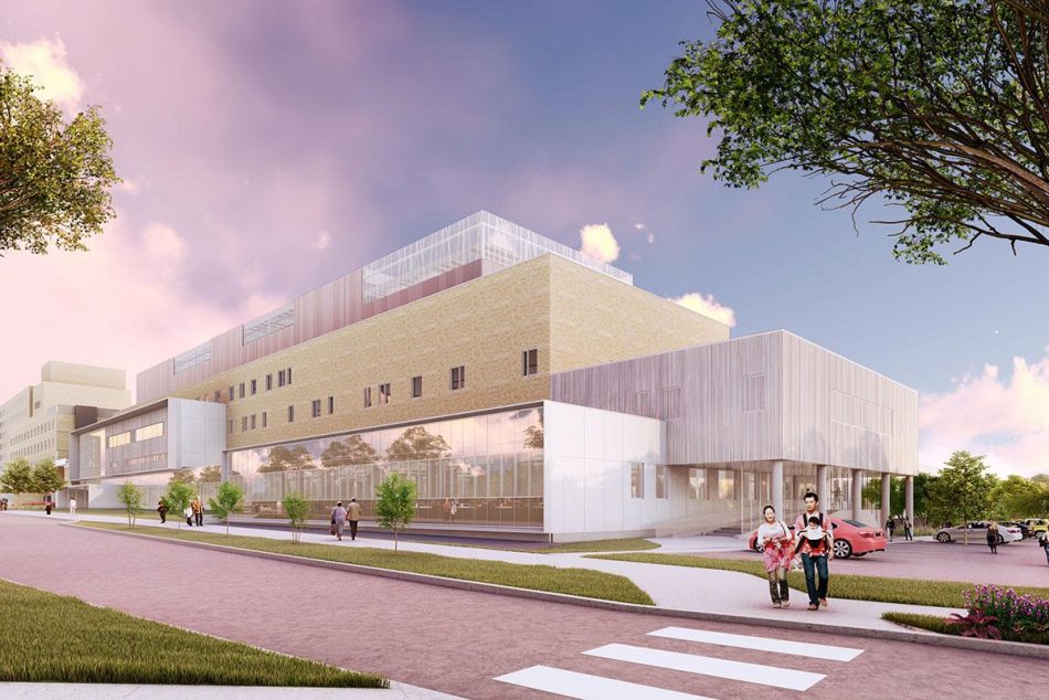 Vue extérieure de l’Hôpital Fleurimont à Sherbrooke, montrant une architecture contemporaine en briques blondes et panneaux métalliques, avec une entrée vitrée et des passants sur le trottoir