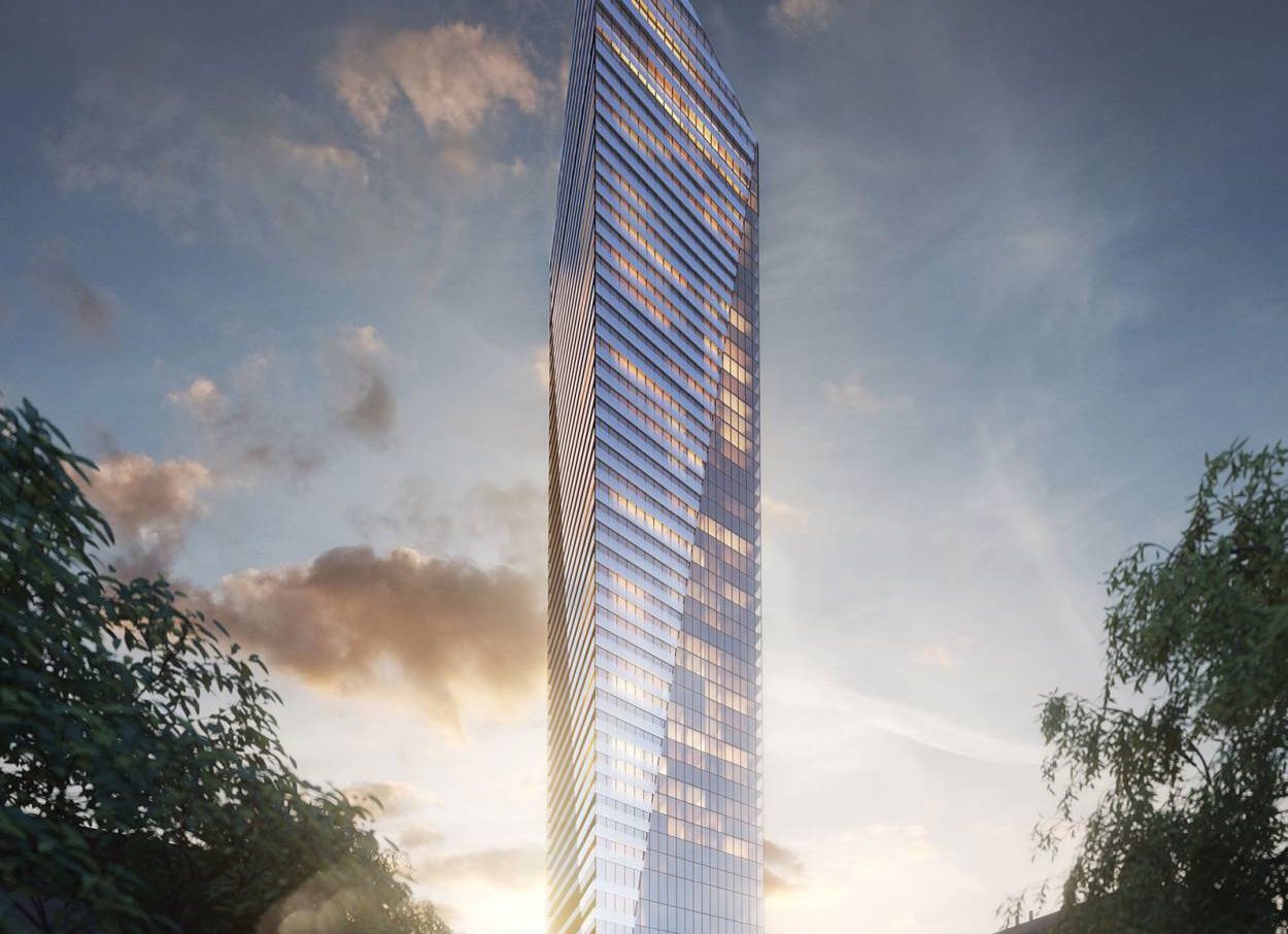 Dusk view of Victoria sur le Parc Tower in Montreal, showcasing its sleek glass architecture and distinctive triangular silhouette in the downtown core