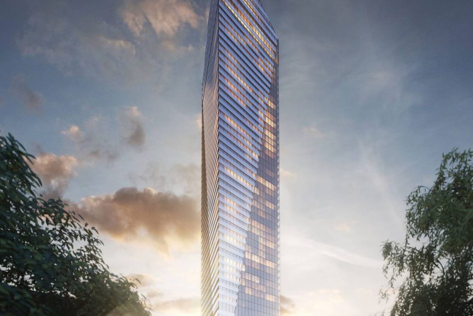 Vue au crépuscule de la Tour Victoria sur le Parc à Montréal, mettant en valeur son architecture élancée en verre et sa silhouette triangulaire distinctive dans le centre-ville